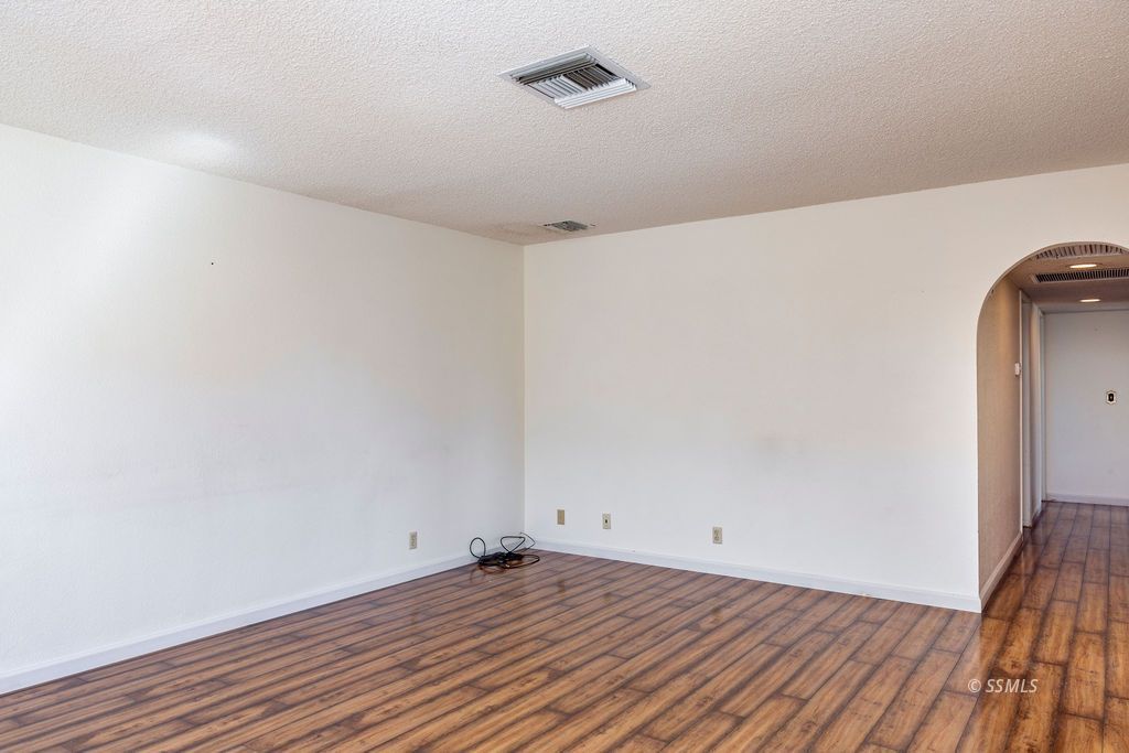 1144 West Benson Avenue Ridgecrest, CA 93555 - Photo 9 of 32 a view of a room with wooden floor