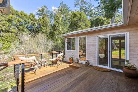a view of a house with backyard and porch
