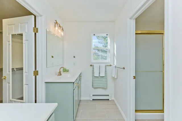 a room with a door open to a room with wooden floor and front door