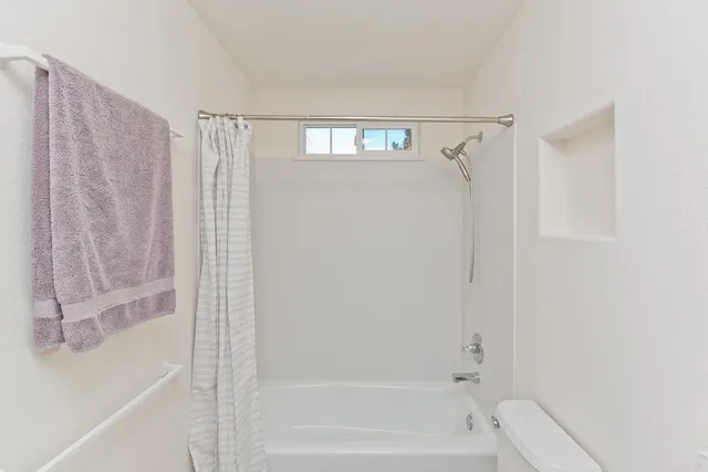 a bathroom with a shower and a bath tub