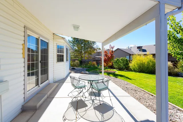 a view of a porch with furniture and garden