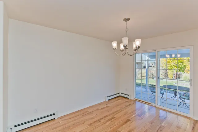 a view of a room with wooden floor and large window
