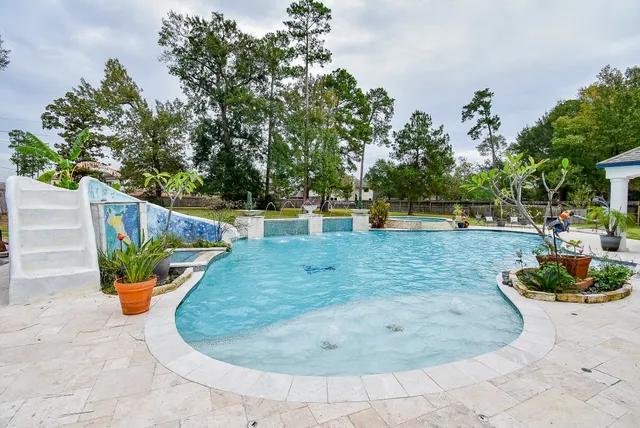 a aerial view of a house with a yard and lake view