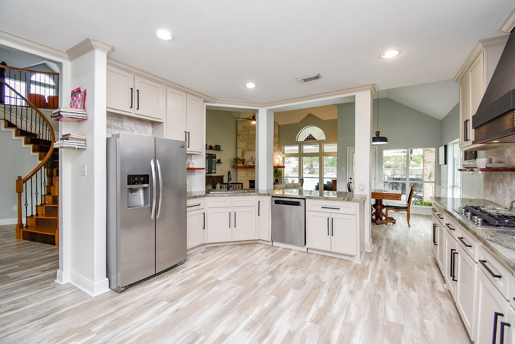 30518 Aldine Westfield Road Spring, TX 77386 - Photo 11 of 50 a kitchen with refrigerator a stove and a wooden floors