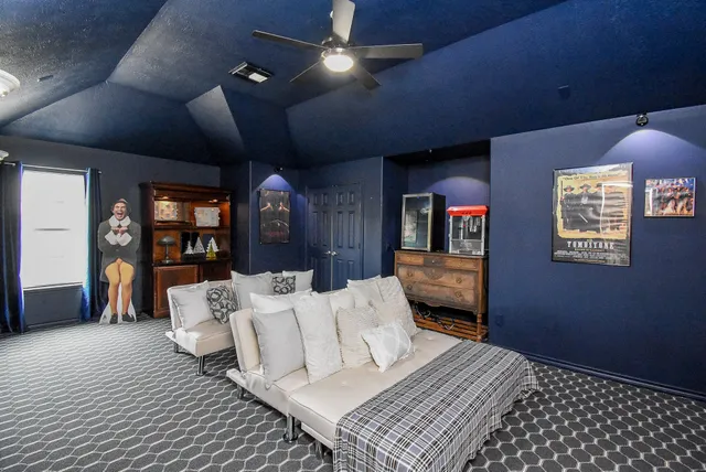 a bedroom with a large bed and a potted plant