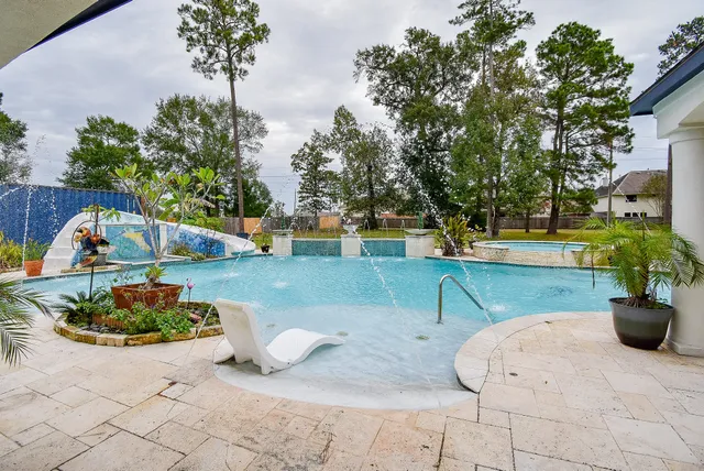 a view of a house with backyard patio and fire pit