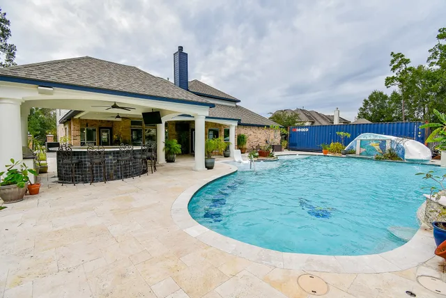 a swimming pool view with a garden and plants