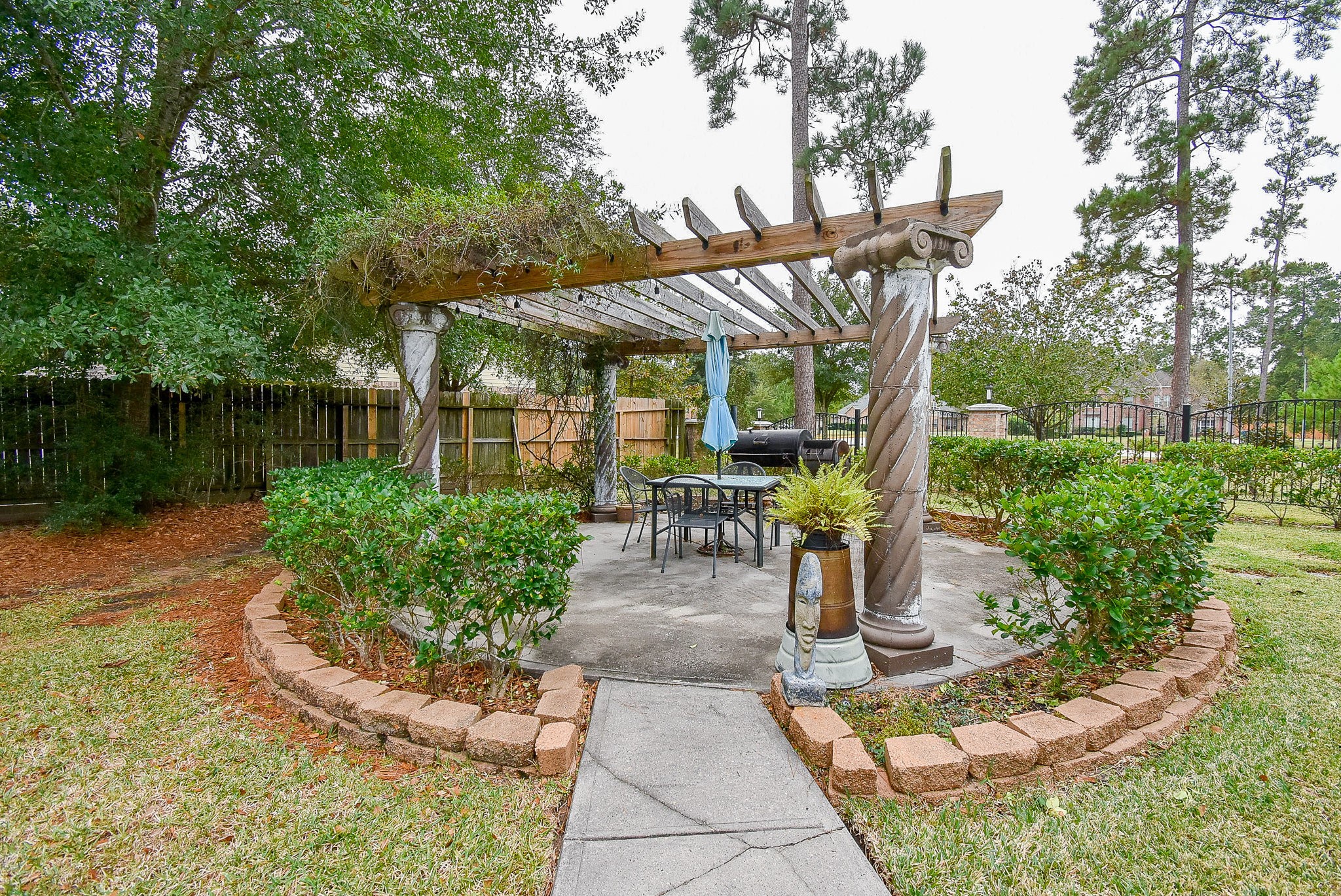 30518 Aldine Westfield Road Spring, TX 77386 - Photo 47 of 50 a view of a patio with table and chairs potted plants and large tree