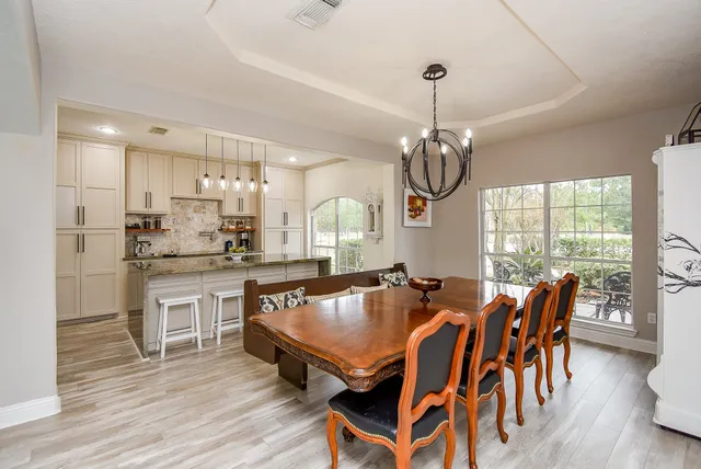 a kitchen with kitchen island a counter top space appliances and cabinets