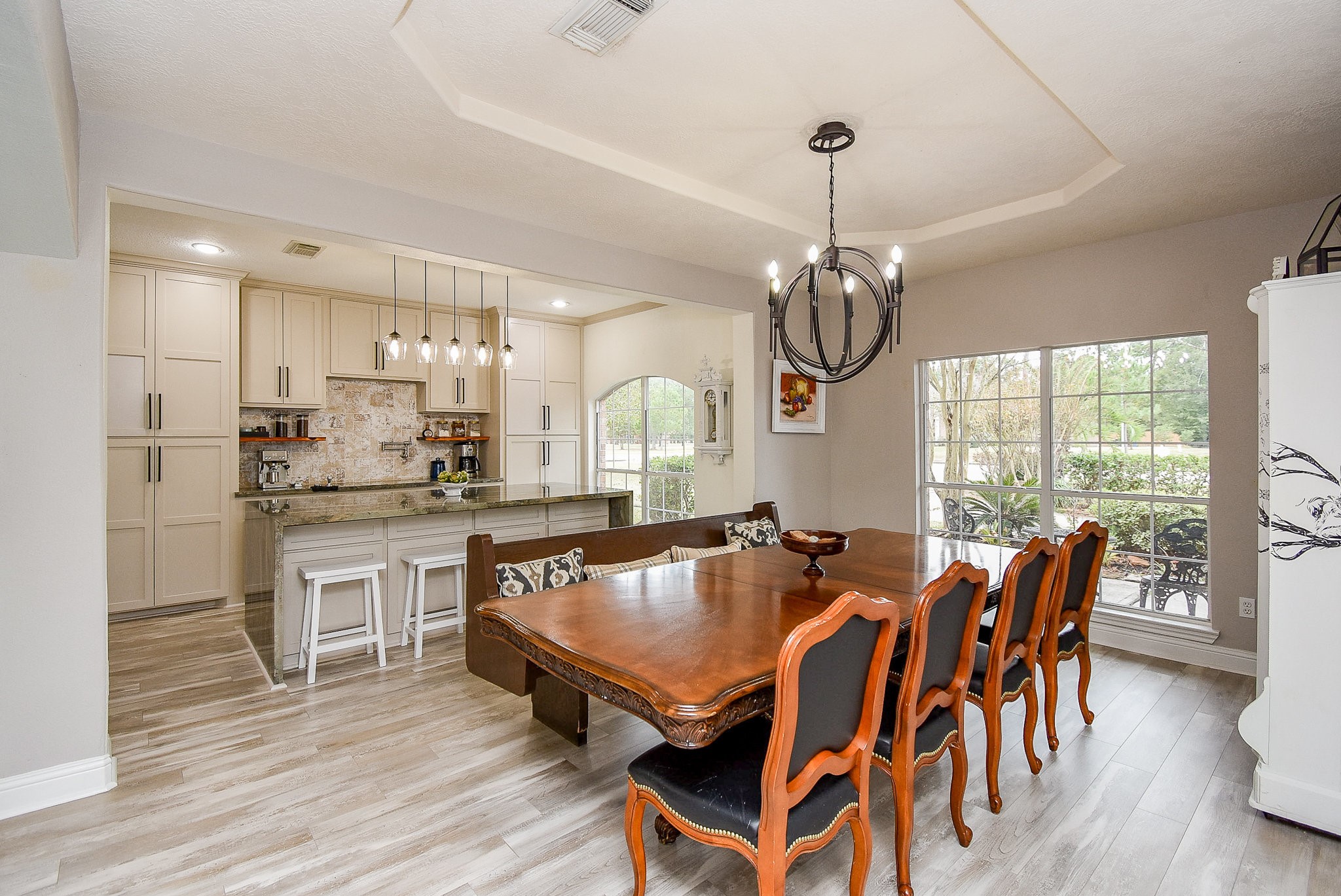 30518 Aldine Westfield Road Spring, TX 77386 - Photo 8 of 50 a kitchen with stainless steel appliances granite countertop a stove top oven a sink dishwasher a dining table and chairs with wooden floor