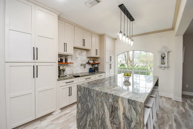 a kitchen with refrigerator a stove and a wooden floors