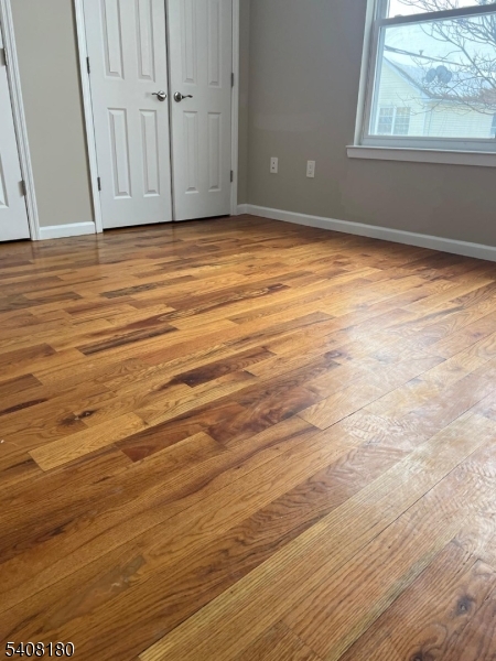 405 South 6th Street, Unit 1 Newark, NJ 07103 - Photo 4 of 8 a view of empty room with window and wooden floor