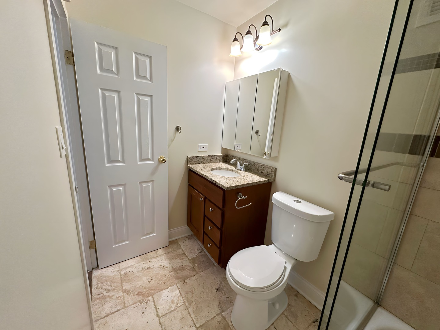 9074 West Terrace Drive, Unit 6D Niles, IL 60714 - Photo 13 of 14 a bathroom with a granite countertop toilet sink and mirror