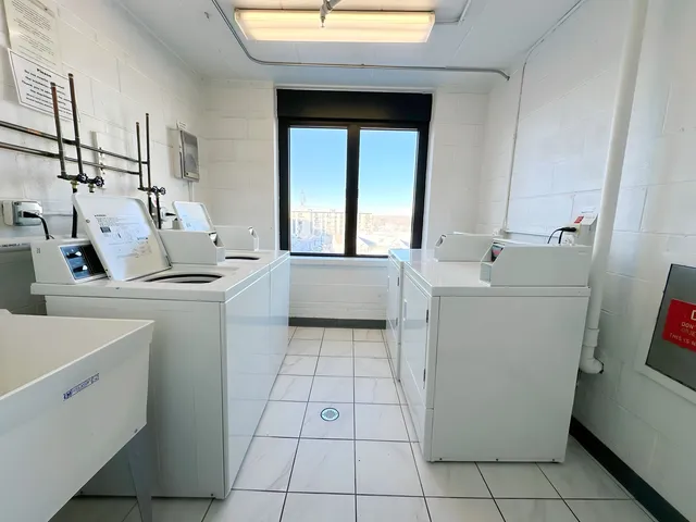a room with a washing machine and sink