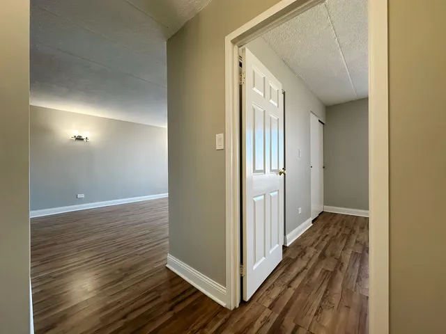 a view of hallway with wooden floor