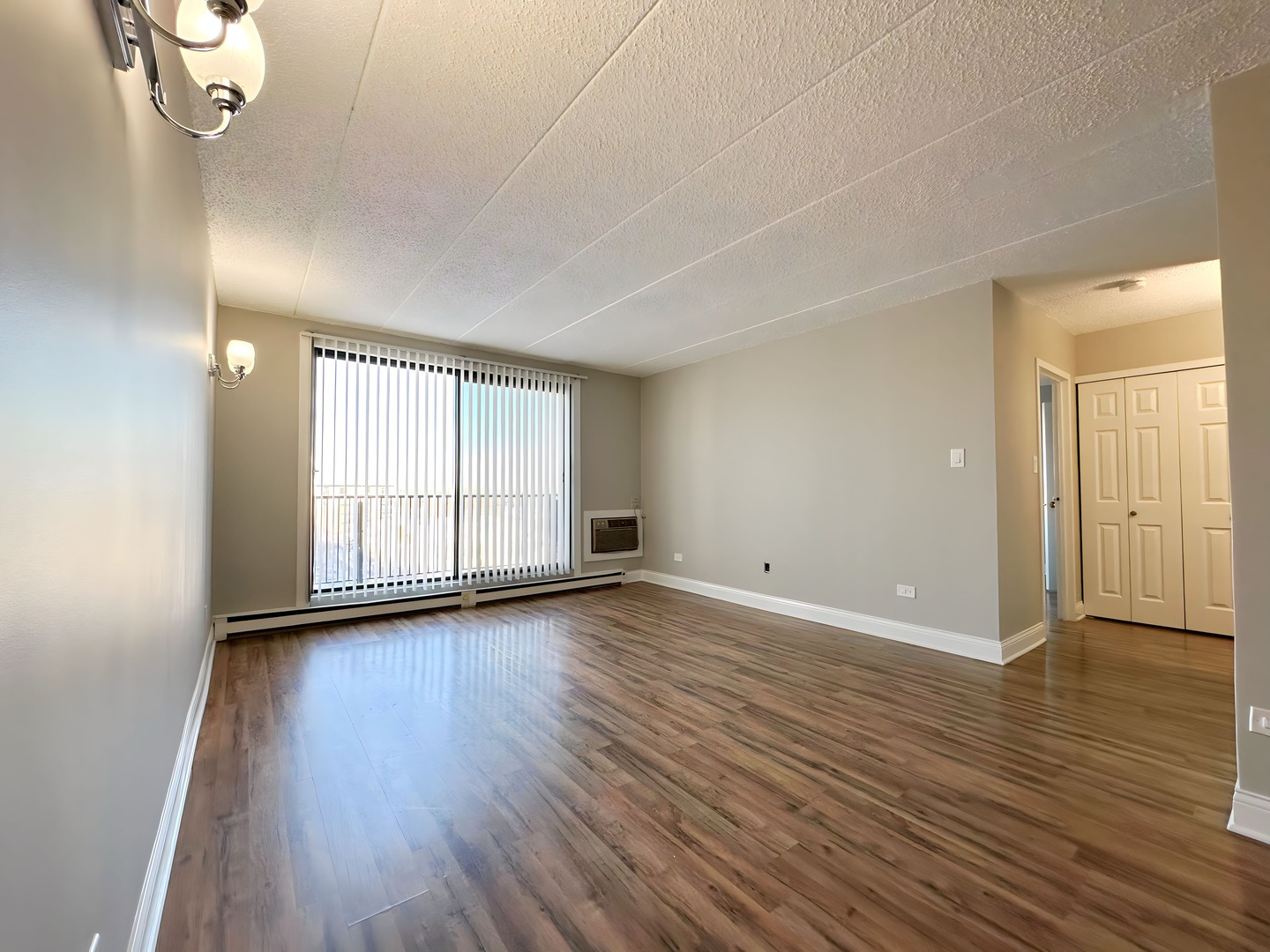9074 West Terrace Drive, Unit 6D Niles, IL 60714 - Photo 5 of 14 an empty room with wooden floor and windows
