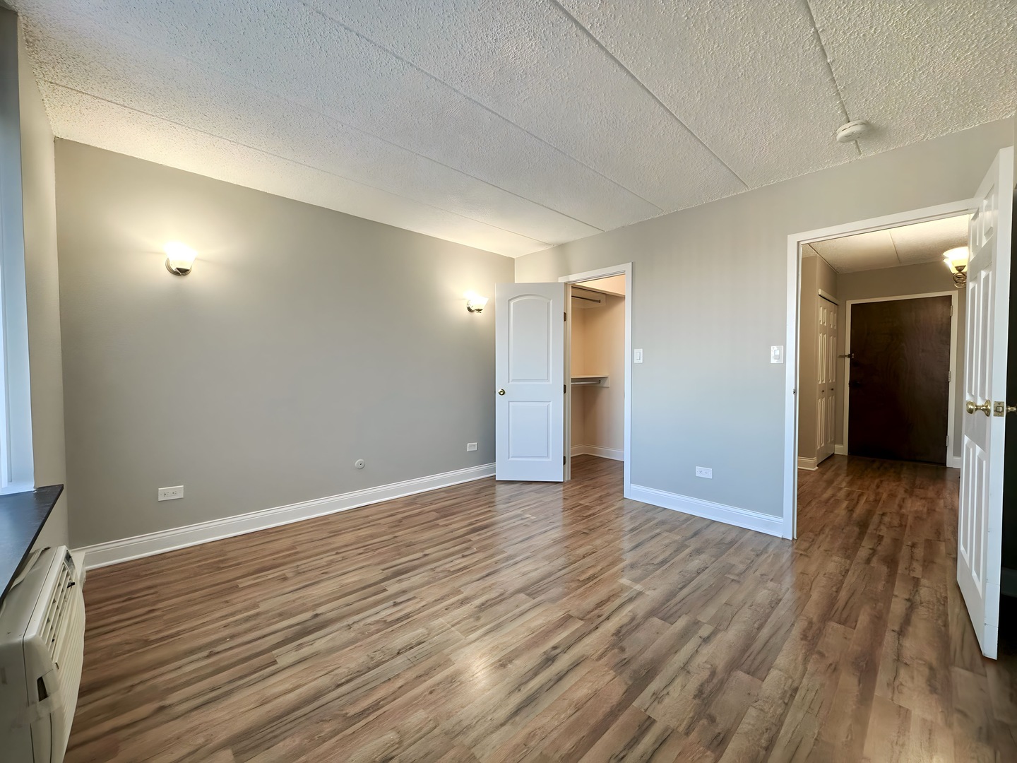 9074 West Terrace Drive, Unit 6D Niles, IL 60714 - Photo 10 of 14 wooden floor in an empty room with a window