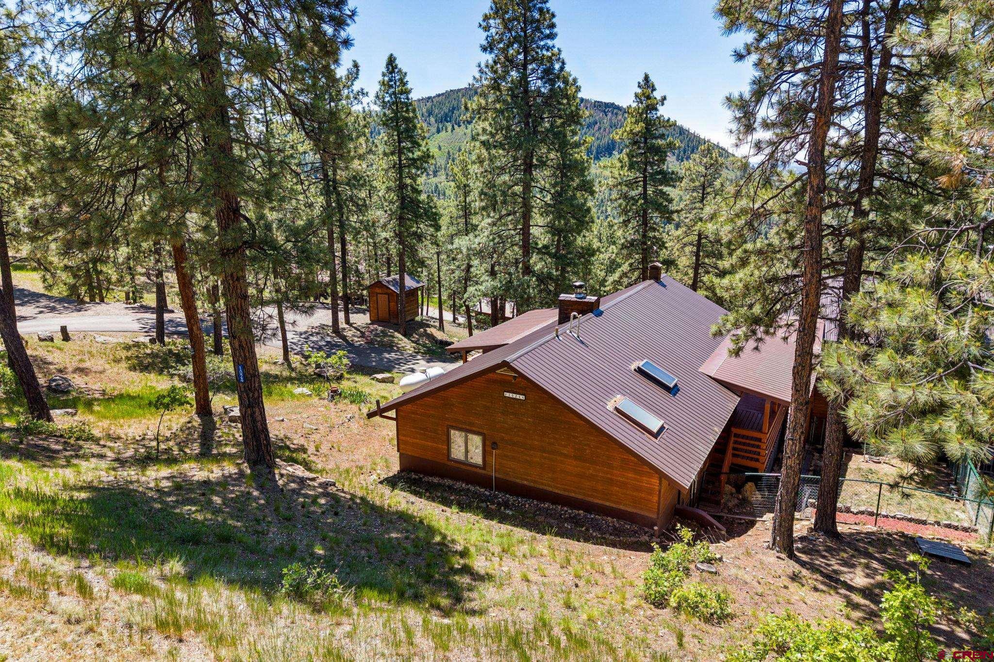1024 Deer Ridge Drive Bayfield, CO 81122 - Photo 42 of 45 an aerial view of a house with a yard water lake and trees all around