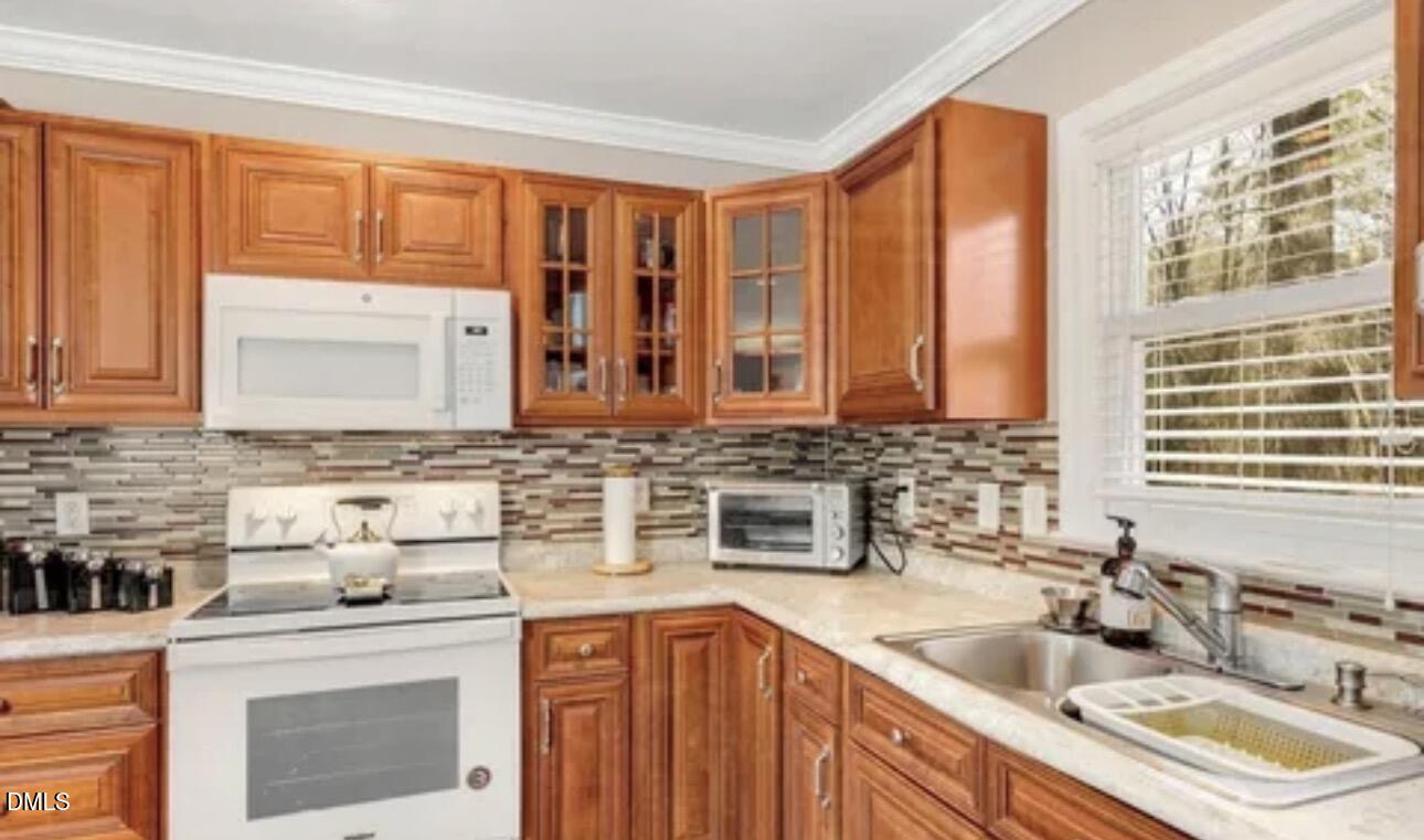 810 Milton Road Durham, NC 27712 - Photo 7 of 21 a kitchen with stainless steel appliances granite countertop a sink stove and cabinets