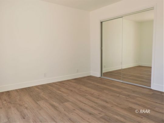 709 West Alene Avenue Ridgecrest, CA 93555 - Photo 10 of 20 a view of an empty room with wooden floor