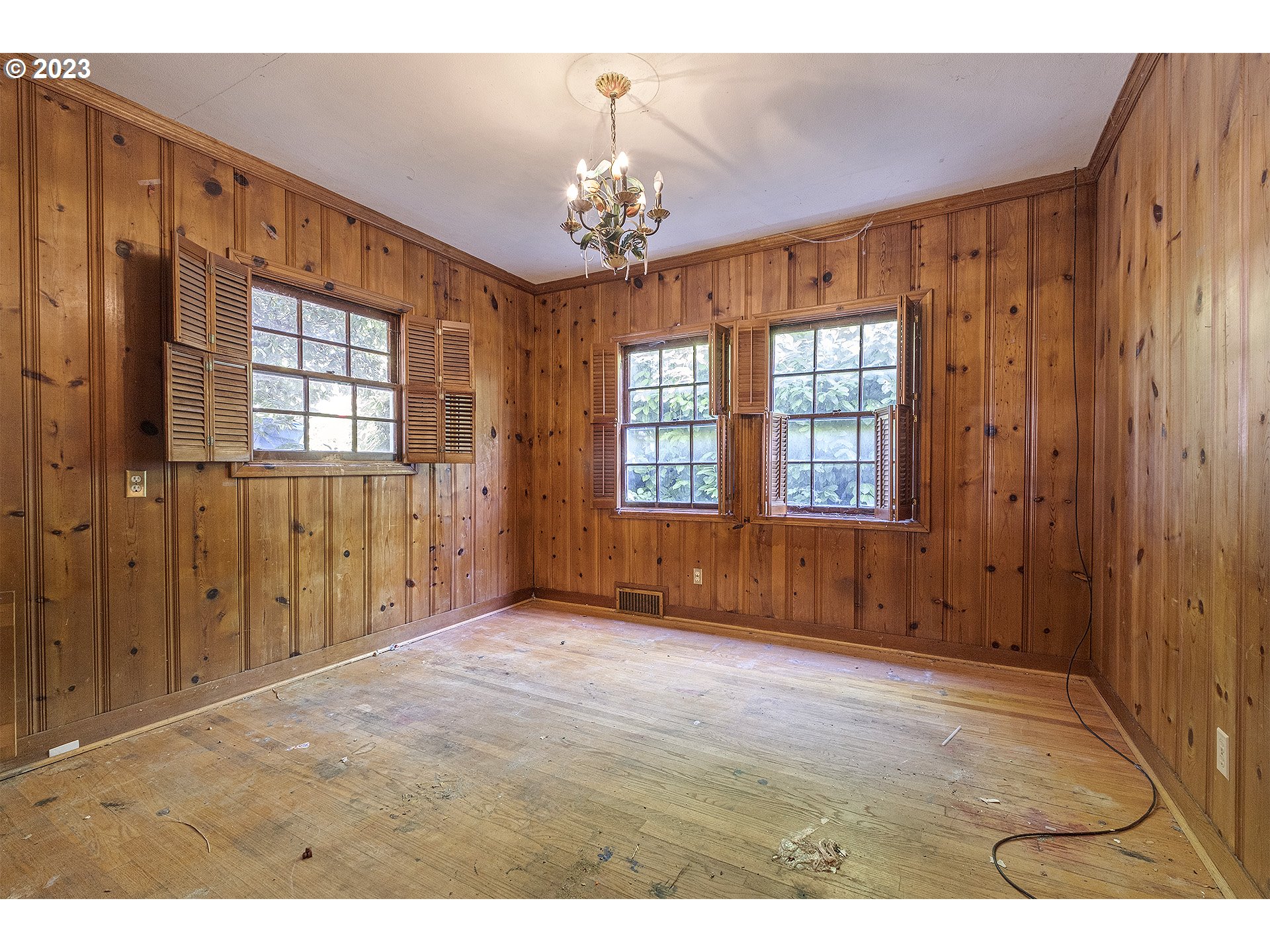 5316 Southwest Menefee Drive Portland, OR 97239 - Photo 3 of 5 a view of an empty room with wooden floor and windows