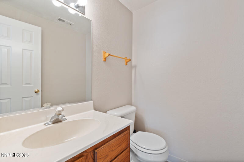 5005 Azurite Drive Reno, NV 89508 - Photo 11 of 33 a bathroom with a sink a toilet and mirror