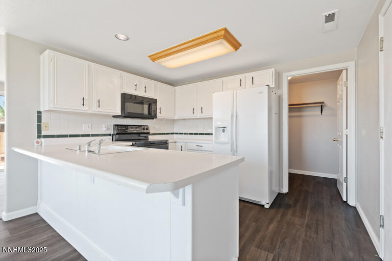 5005 Azurite Drive Reno, NV 89508 - Photo 2 of 33 a kitchen with stainless steel appliances a refrigerator sink and white cabinets
