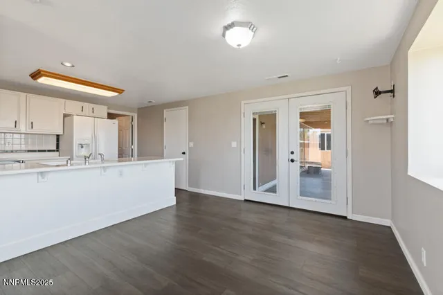 a view of a kitchen with wooden floor and electronic appliances