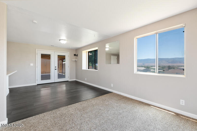 5005 Azurite Drive Reno, NV 89508 - Photo 5 of 33 an empty room with wooden floor and windows