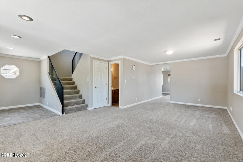 5005 Azurite Drive Reno, NV 89508 - Photo 9 of 33 an empty room with a staircase and white walls