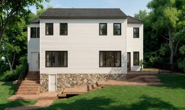 a front view of a house with a garden