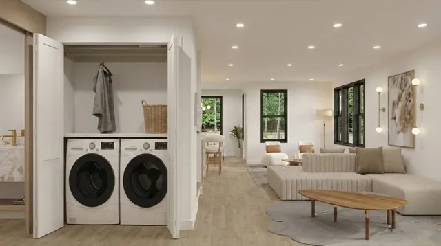 a living room with furniture and a view of kitchen