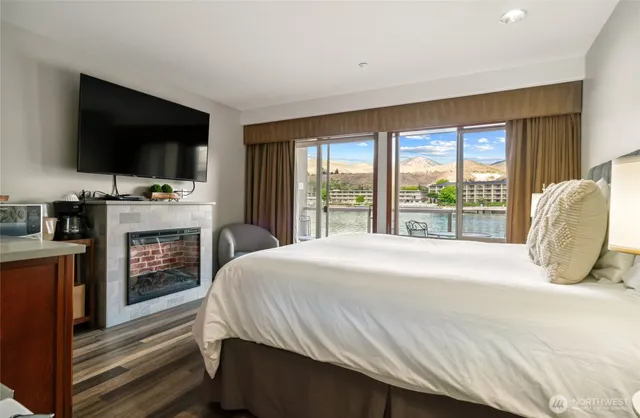 a bedroom with a bed and a flat screen tv