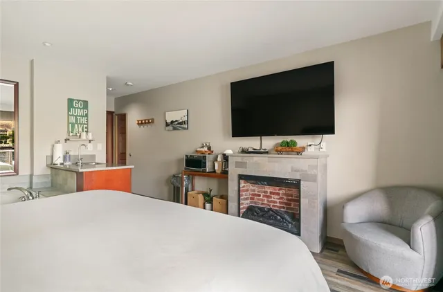 a bedroom with a bed and a flat screen tv