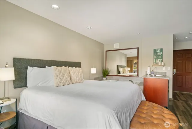 a bedroom with a bed mirror and window