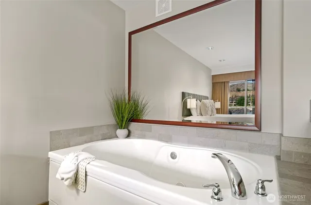 a bathroom with a tub and sink
