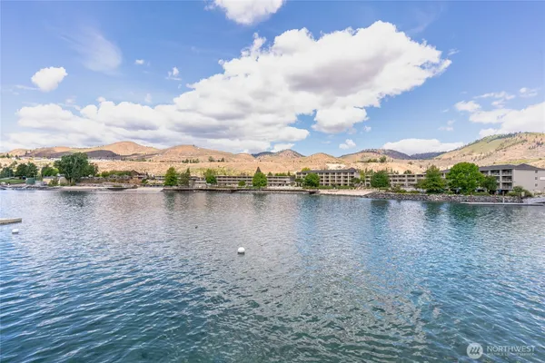 a view of a lake with houses in the back