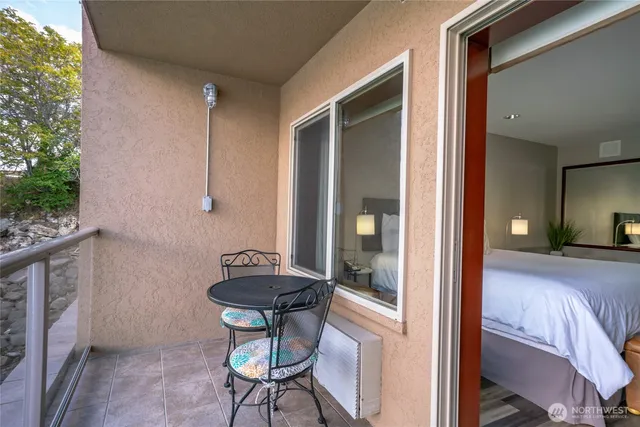 a view of a room that has a bed and a chair