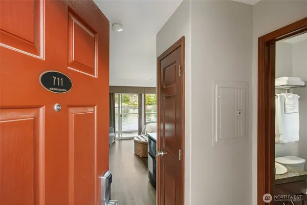 a view of a hallway with a door and a closet