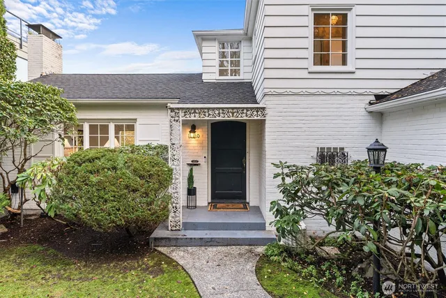 a front view of a house with a garden