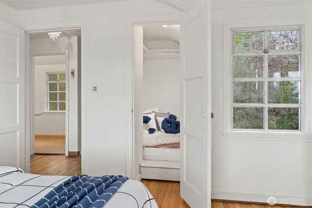 a bedroom with a bed and a window