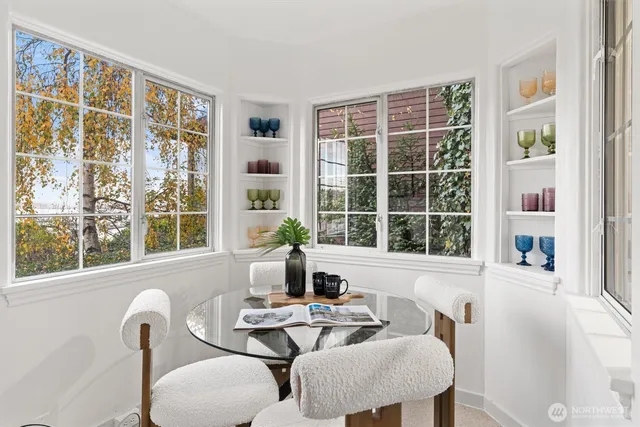 a dining room with wooden floor a chandelier a wooden table and chairs