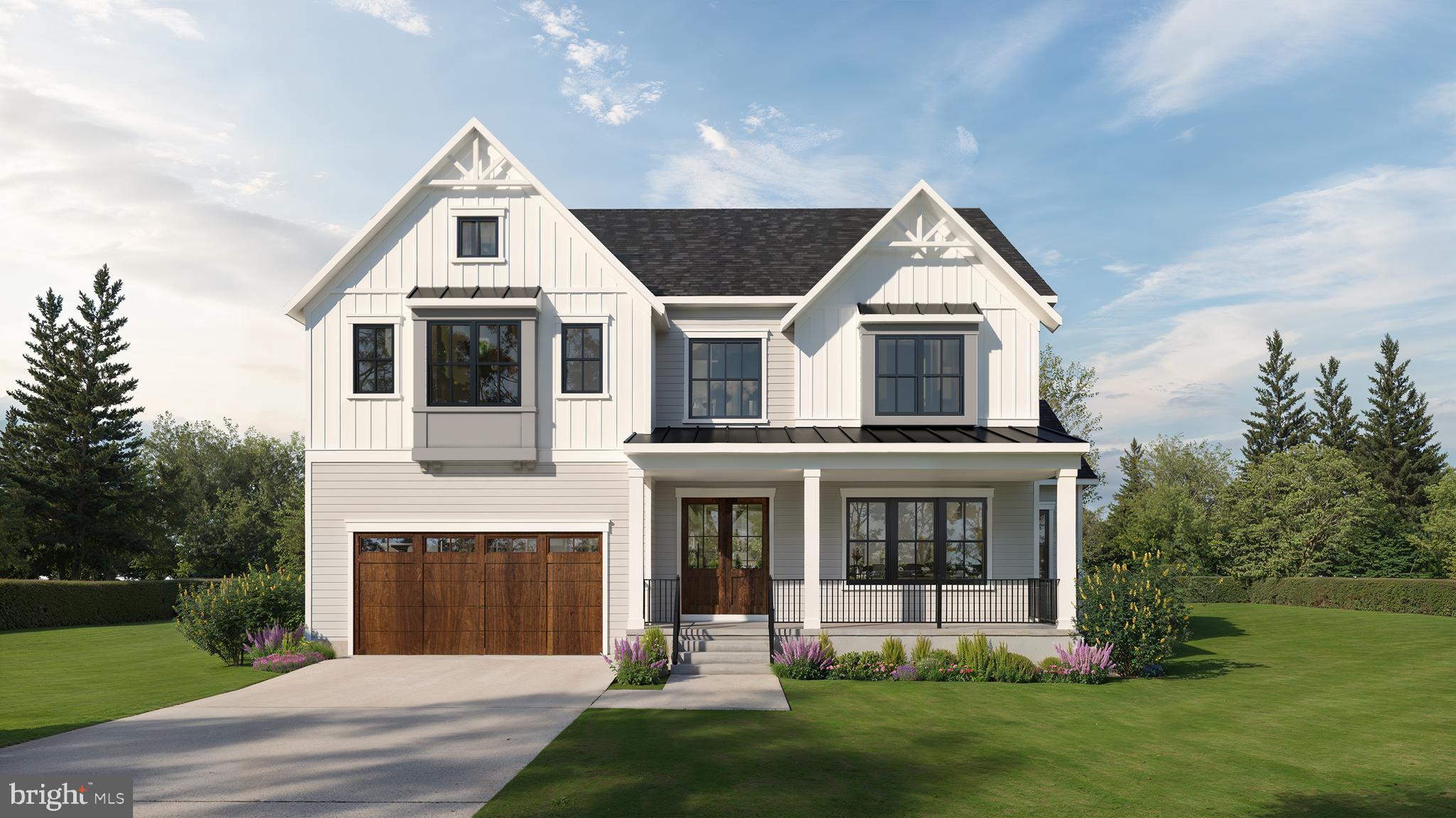 a front view of a house with a yard and trees