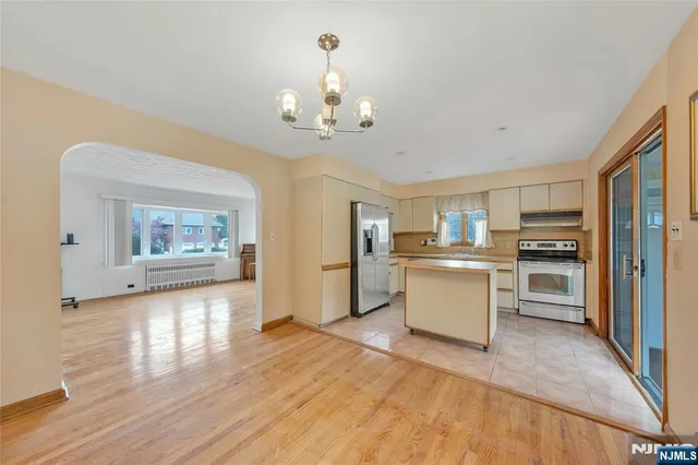 a kitchen with a refrigerator and a stove top oven