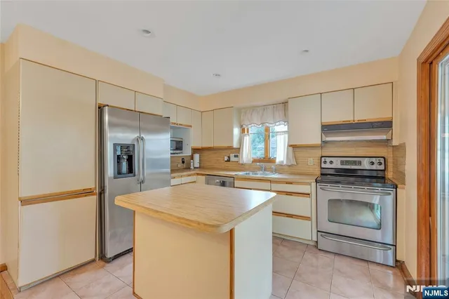 a kitchen with a stove sink and refrigerator