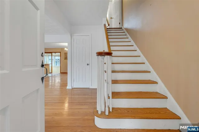 a view of entryway and hall with wooden floor