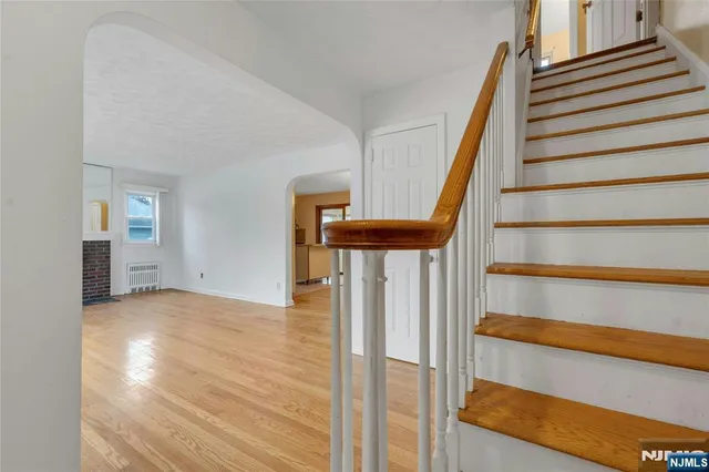 a view of entryway with wooden floor and front door