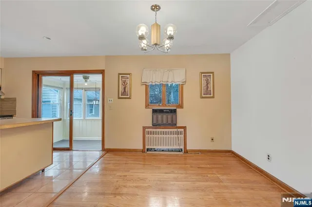 a view of a livingroom with wooden floor and a chandelier