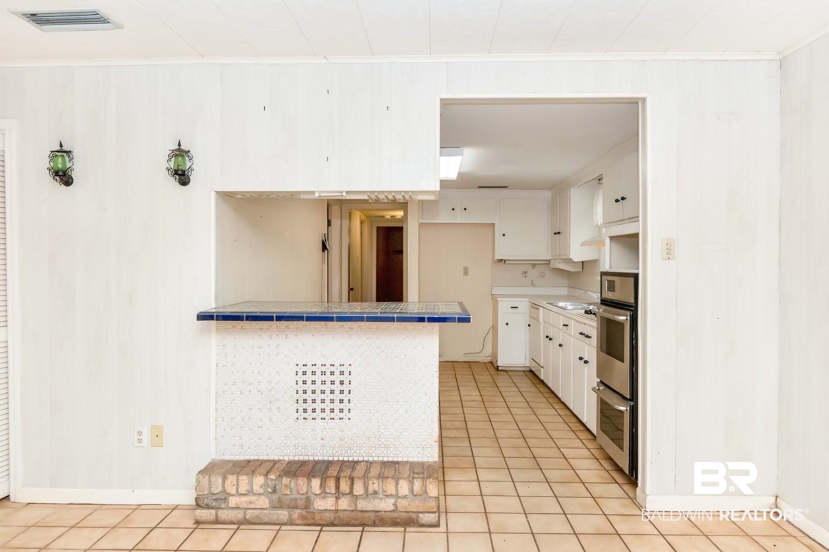 3715 South Conway Drive Mobile, AL 36608 - Photo 3 of 24 Kitchen with tile counters, visible vents, white cabinetry, and oven