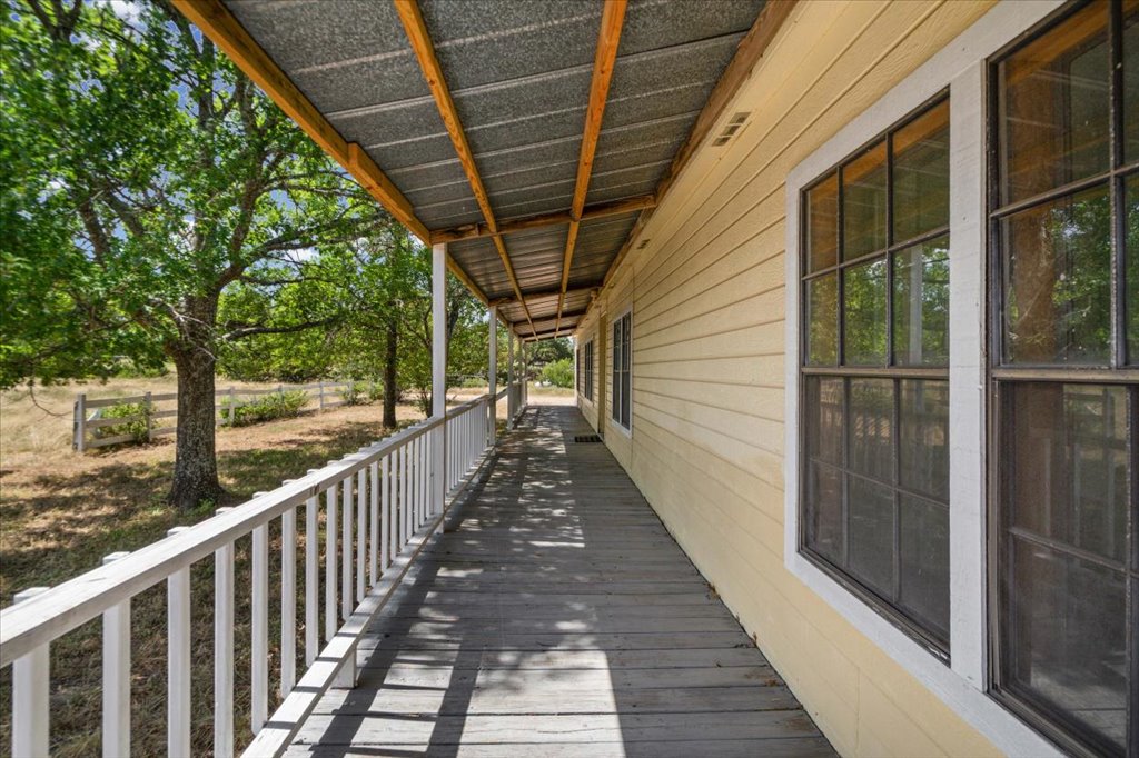 13501 Nutty Brown Road, Unit B Austin, TX 78737 - Photo 28 of 29 An inviting covered porch extends along the home, offering ample shade and tranquil views of the verdant yard.